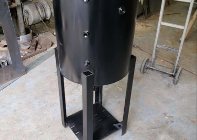 Round black tank with several threaded bungs