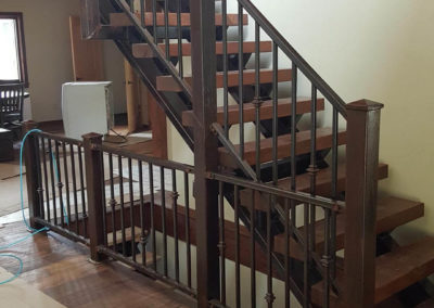 Rust brown railing and stair stinger with 4x12 wood stair treads