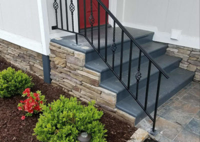 Black entry railing with forged steel basket twists in the spindle