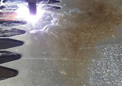 Sparks fly as the plasma table cuts through some sheet aluminum