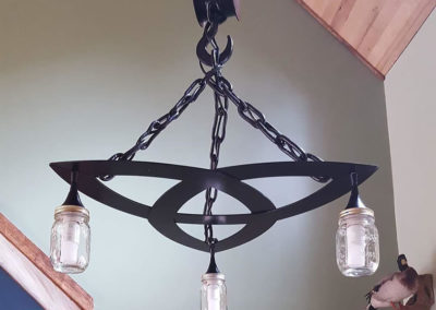 Celtic know light fixture with 3 mason jars hanging from chains